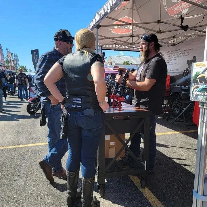 People talking beside a vendor booth